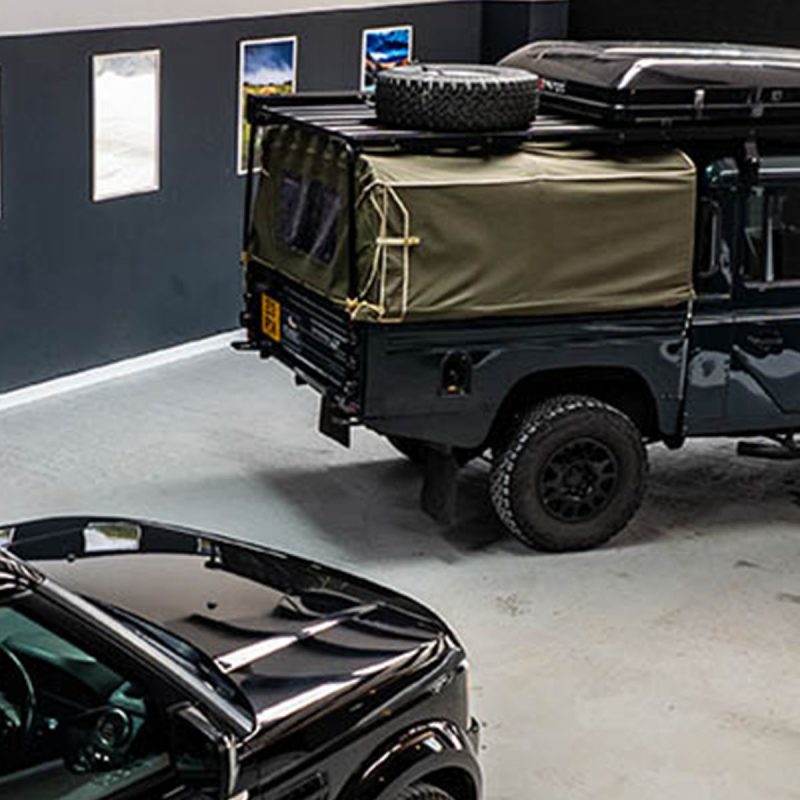Two Land Rovers parked in the garage at the office of Nomadic Scotland