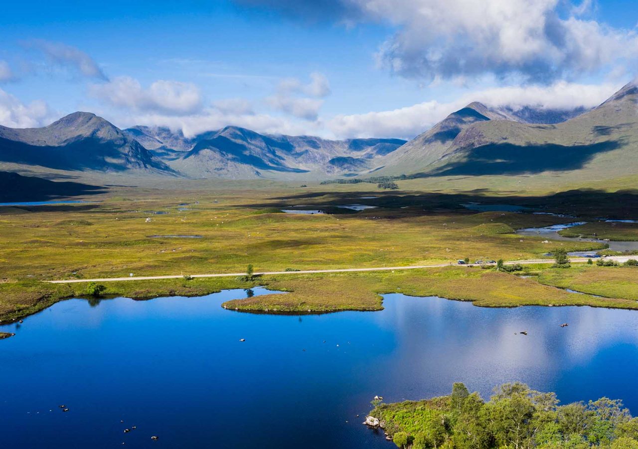 Stunning Scottish scenery with a glistening loch in the foreground and mountains in the background