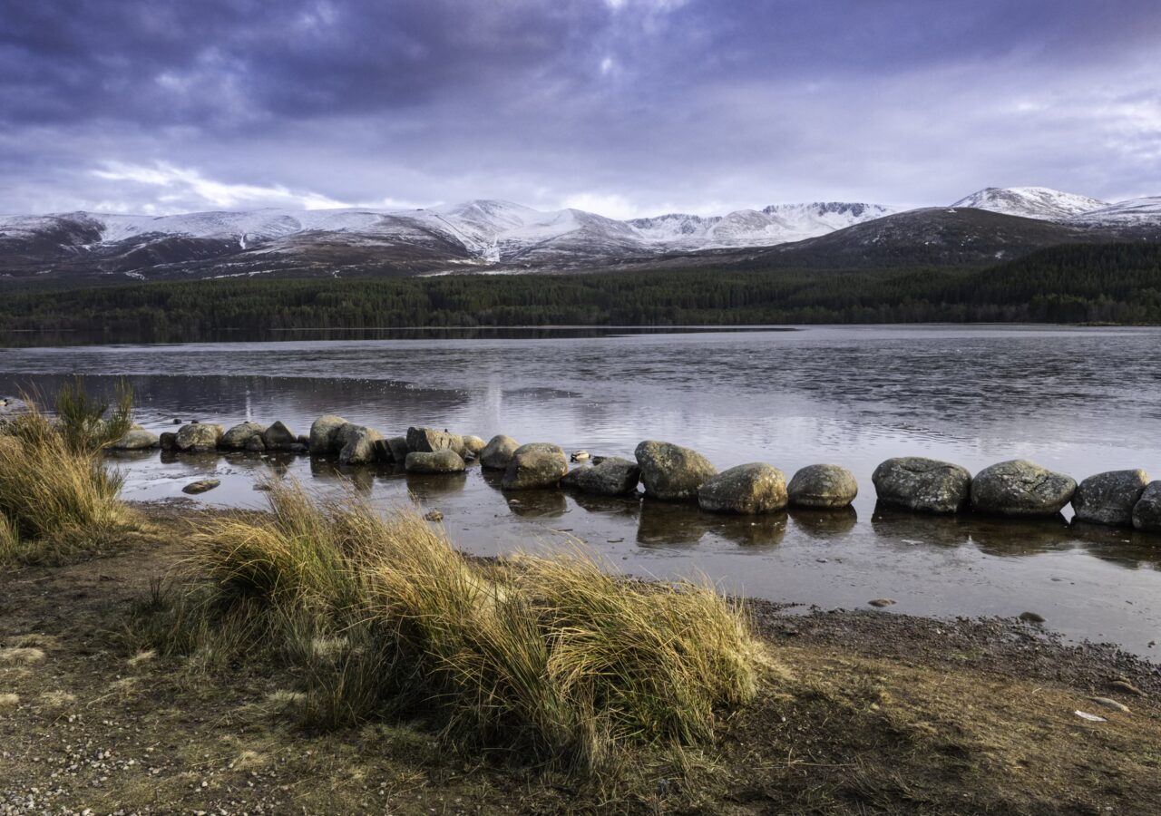 A loch with snowy mountains in the distance - perfect for a cold water dip