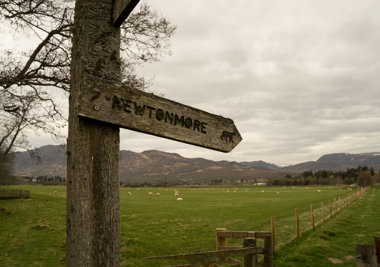 Signpost in the Scottish Highlands pointing the way to Newtonmore