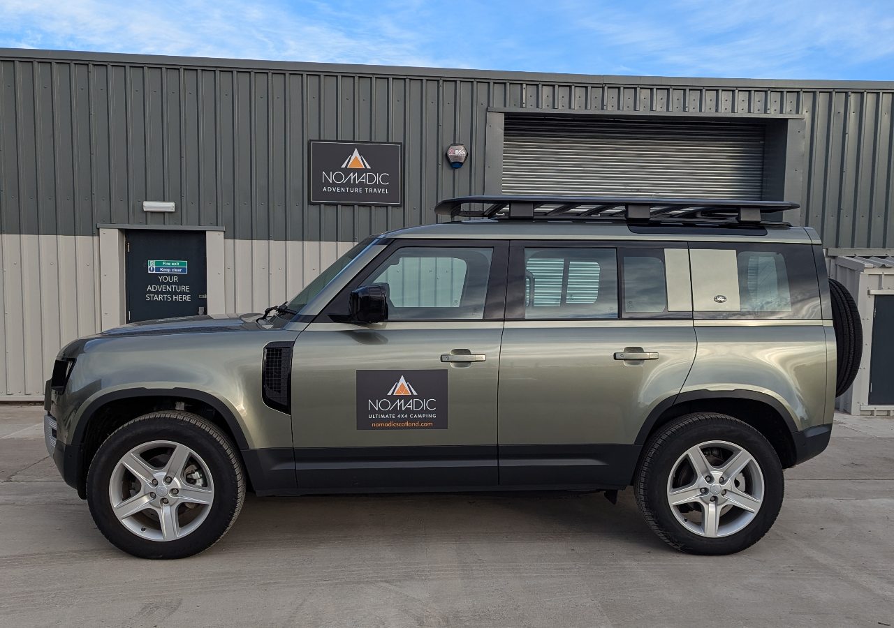 A new style Land Rover 4x4 vehicle for hire on a sunny day in Scotland.