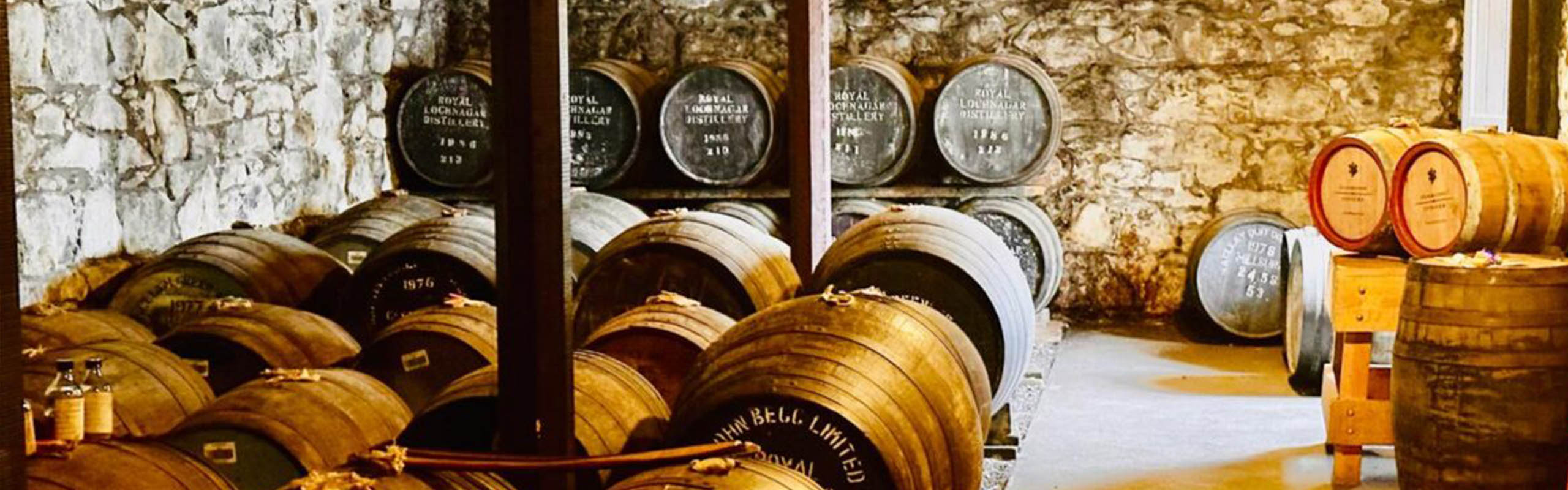 Whisky barrels stored in a stone cellar