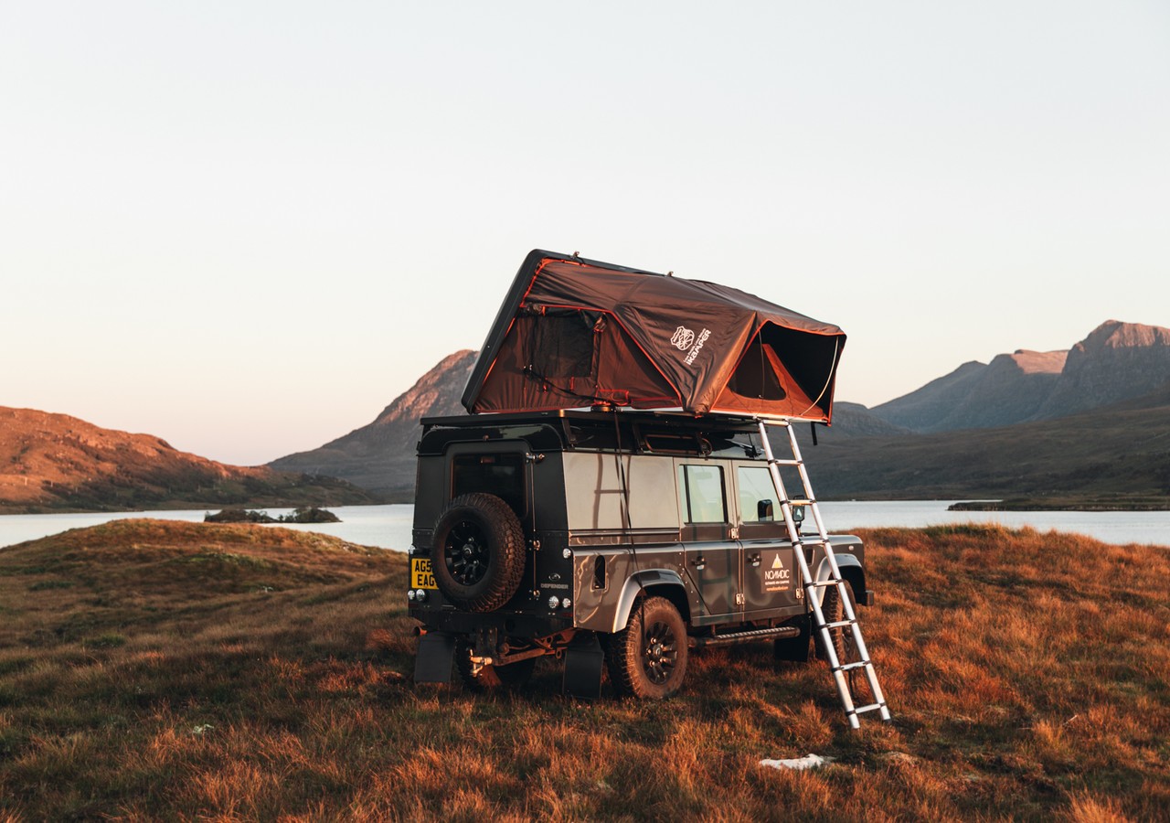 Land Rover Defender with roof tent, an example of 4x4 camping Scotland.