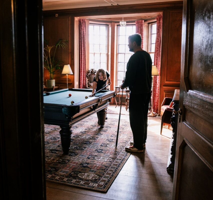 A guest walking through the panelled hotel